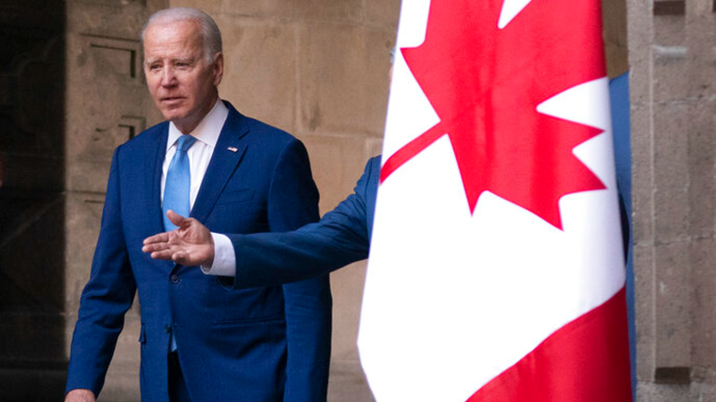 Joe Biden next to a Canadian flag